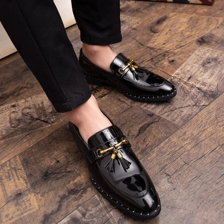 Fashion-forward men's polished tassel loafers with gold accents, sophisticated evening wear shoes.