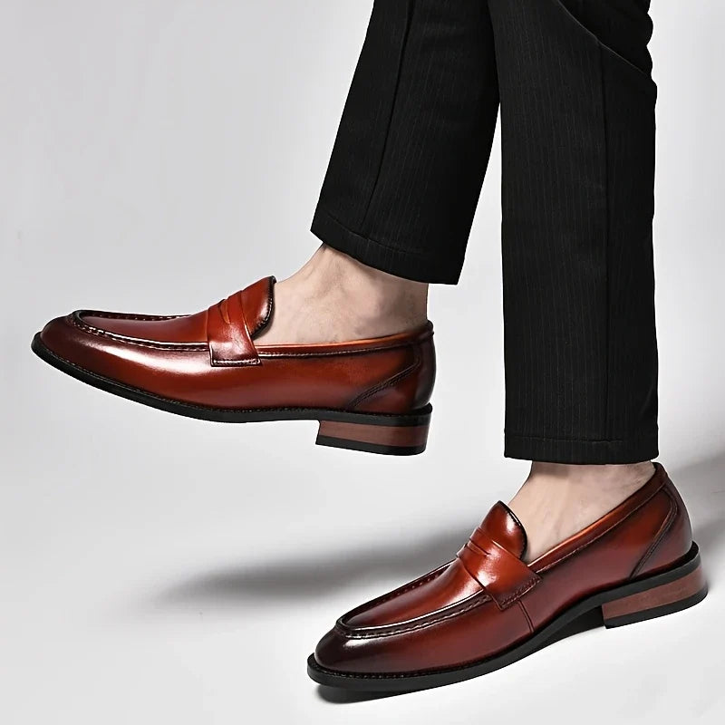 Comfortable men's polished slip-on loafers, versatile for sophisticated dress shoes or casual elegant looks.