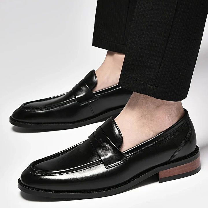 Men's polished leather slip-on loafers for a refined classic style, ideal as comfortable dress shoes.