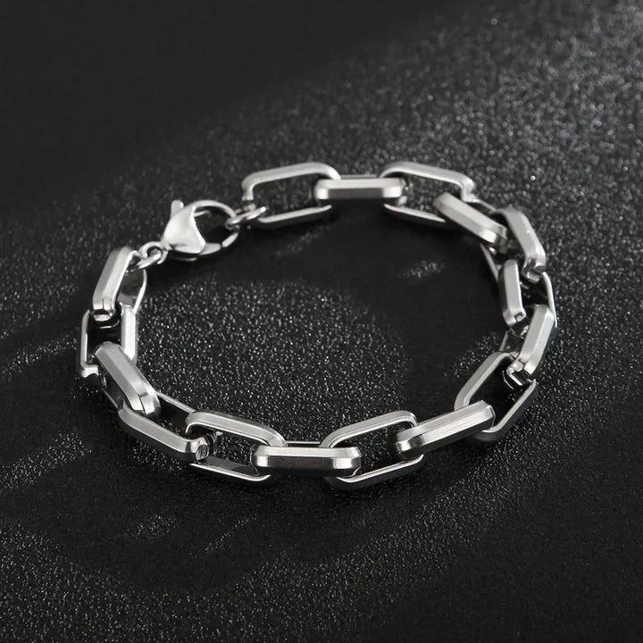 Close-up of a men's stainless steel chain bracelet, showcasing its polished finish & sleek design. Modern men's jewelry.