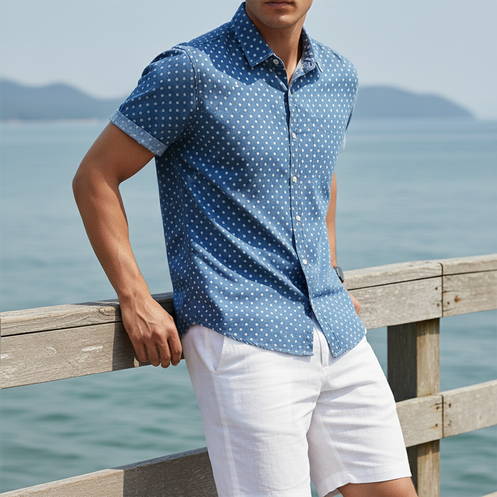 Relaxed fit men's cabana shirt, white polka dots on a dark background. Short-sleeve summer apparel.
