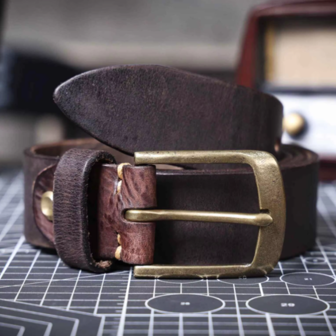 Elegant gift idea: A men's durable brown cowhide leather belt with a polished buckle, perfect for any man.
