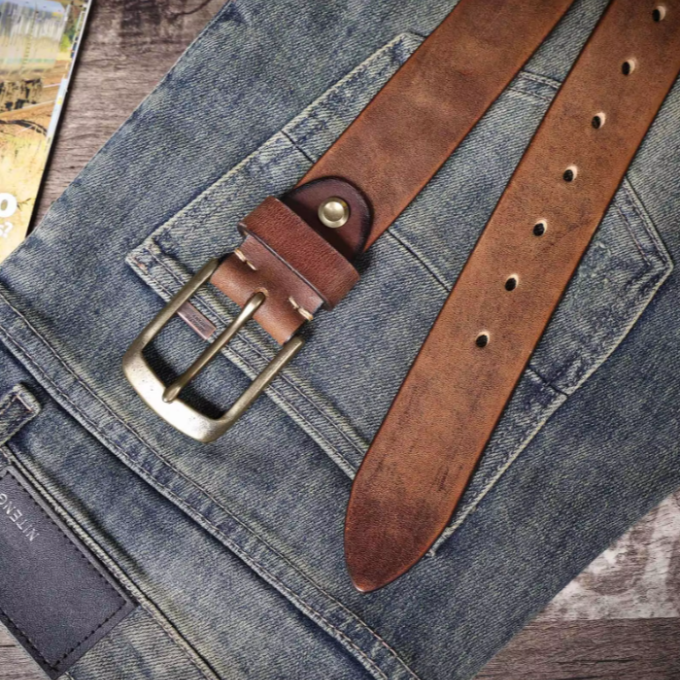 Stylish men's durable brown leather belt, coiled neatly to highlight its premium cowhide quality and craftsmanship.
