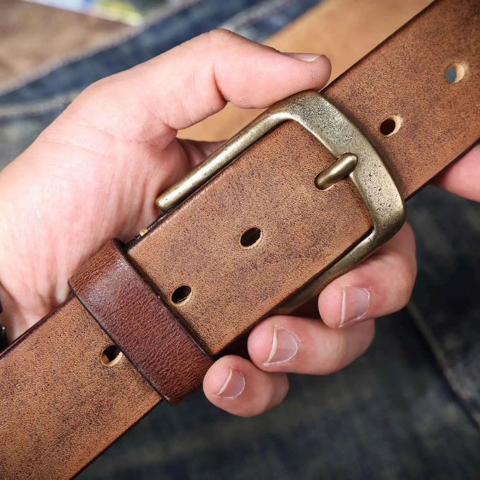 Men's timeless brown cowhide leather belt, laid flat to display its smooth finish and sturdy design.