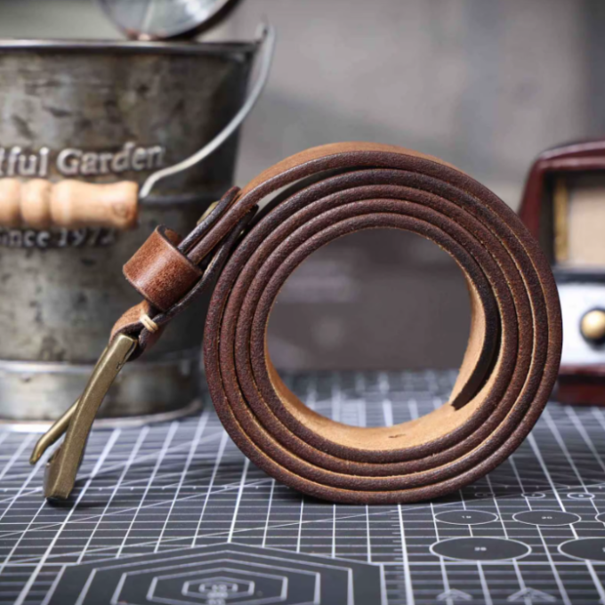 Exquisite stitching detail on a durable men's premium cowhide leather belt with a polished buckle.