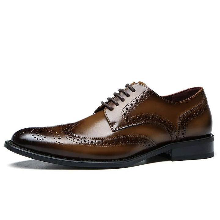 Intricate wingtip men's leather brogue Oxford dress shoes, featuring decorative perforations and a classic silhouette.