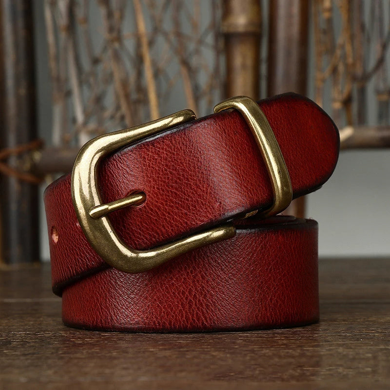 Close-up of men's full-grain leather belt with a polished brass buckle, showcasing quality.