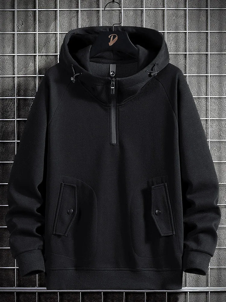 Relaxed fit men's quarter-zip hoodie, a comfortable pullover with practical flap pockets for casual style.