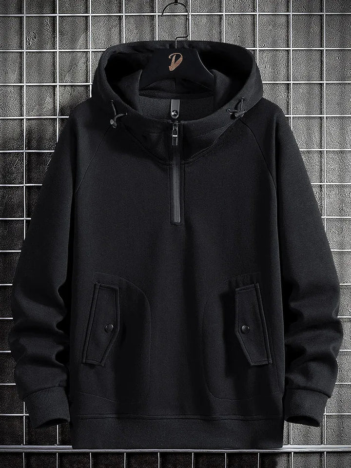 Relaxed fit men's quarter-zip hoodie, a comfortable pullover with practical flap pockets for casual style.