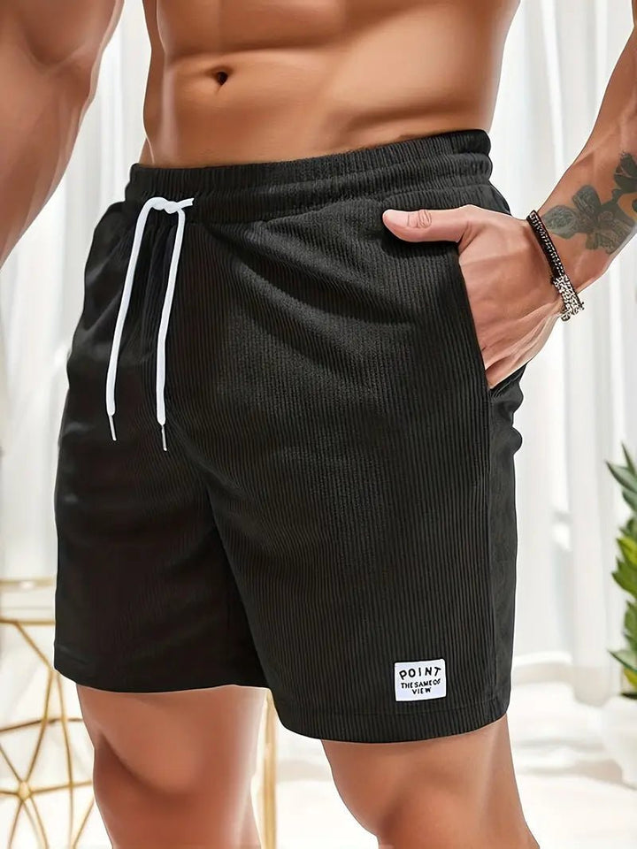 Men's quick-dry beach shorts with elastic waist, perfect for swimming and sunbathing.