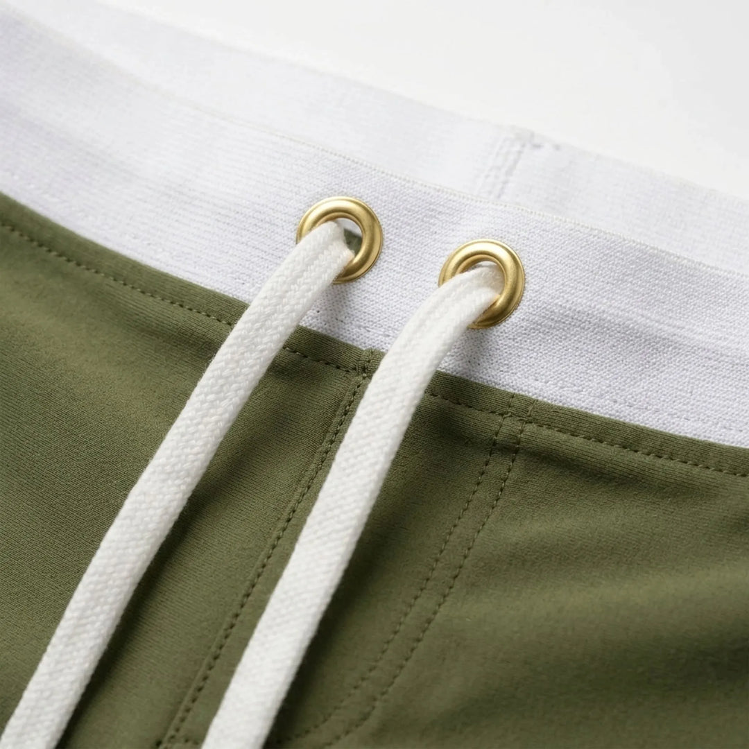Athletic men's quick-dry fitted swim trunks, solid color, ideal for swimming & beach sports.