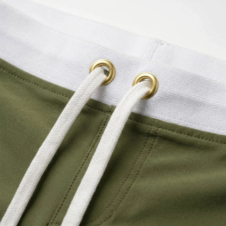 Athletic men's quick-dry fitted swim trunks, solid color, ideal for swimming & beach sports.