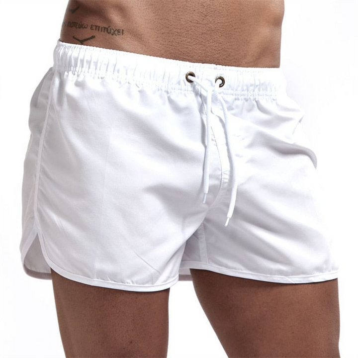 Men's quick-dry swim shorts in blue with a comfortable elastic waistband, ideal for beachwear or pool.