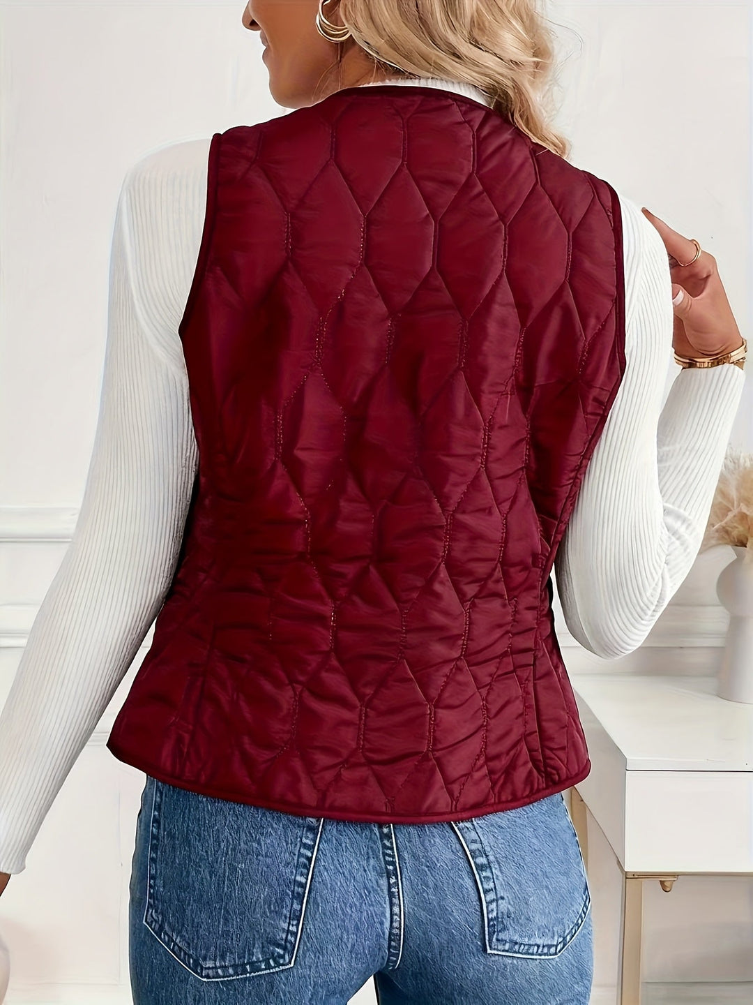 Men's quilted bomber vest with sherpa lining, shown layered. A warm and versatile piece for winter outerwear.