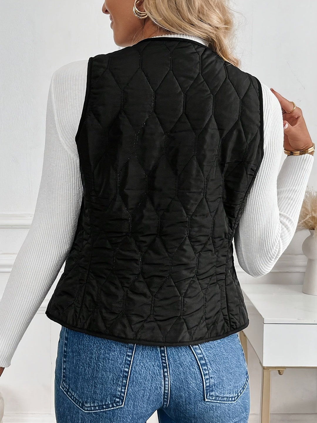 Side profile of a men's quilted bomber vest with plush sherpa lining, designed for comfortable winter layering.