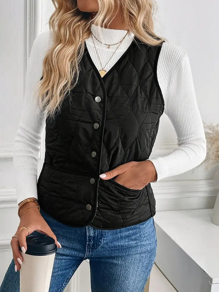 Detail of zipper and pocket on a men's quilted bomber vest with warm sherpa lining. Functional winter outerwear.