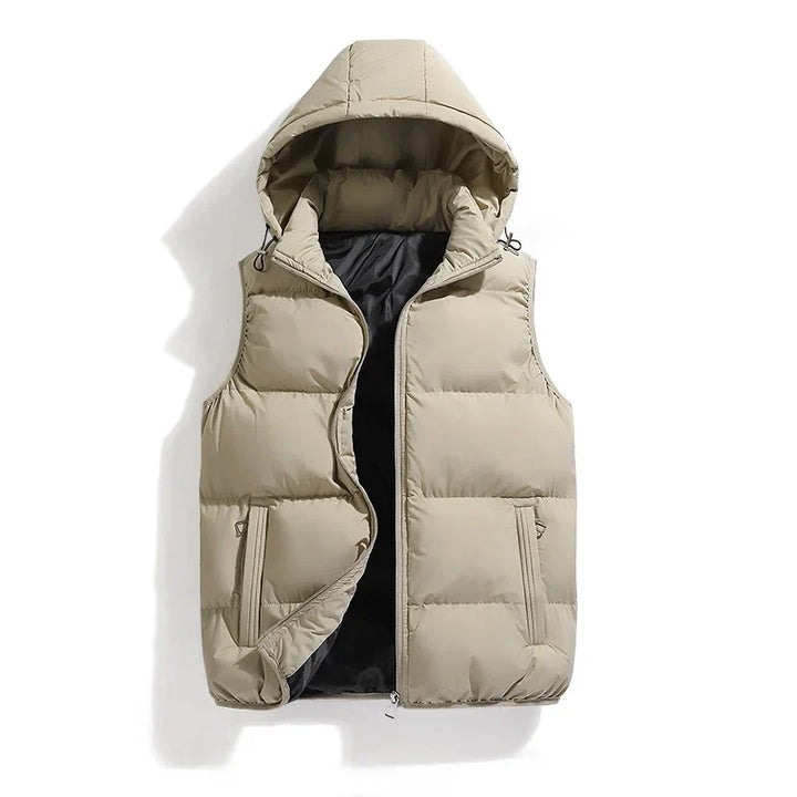 Close-up: Men's quilted utility vest, detailing fabric, zipper pockets, and detachable hood. Durable men's casual wear.