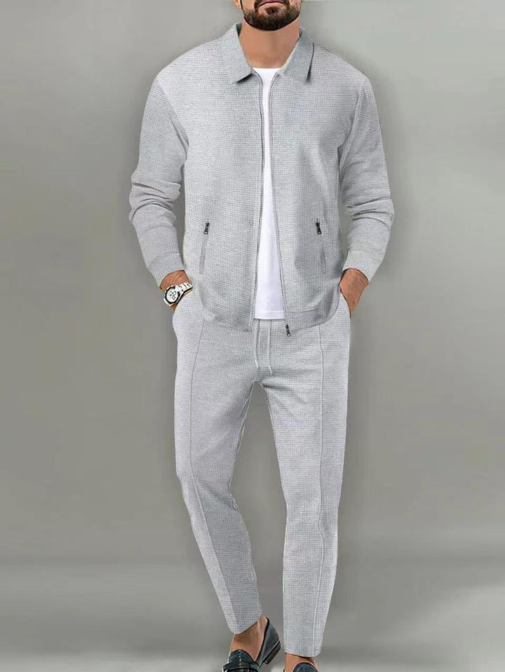 Man wearing modern fit Ravenna men's tracksuit, showcasing athletic wear style & comfort for active lifestyles.