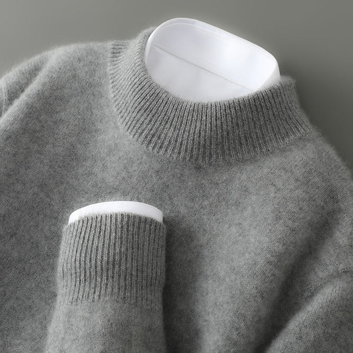 Man models refined pullover sweater for elegant fall/winter fashion. Comfortable menswear style.