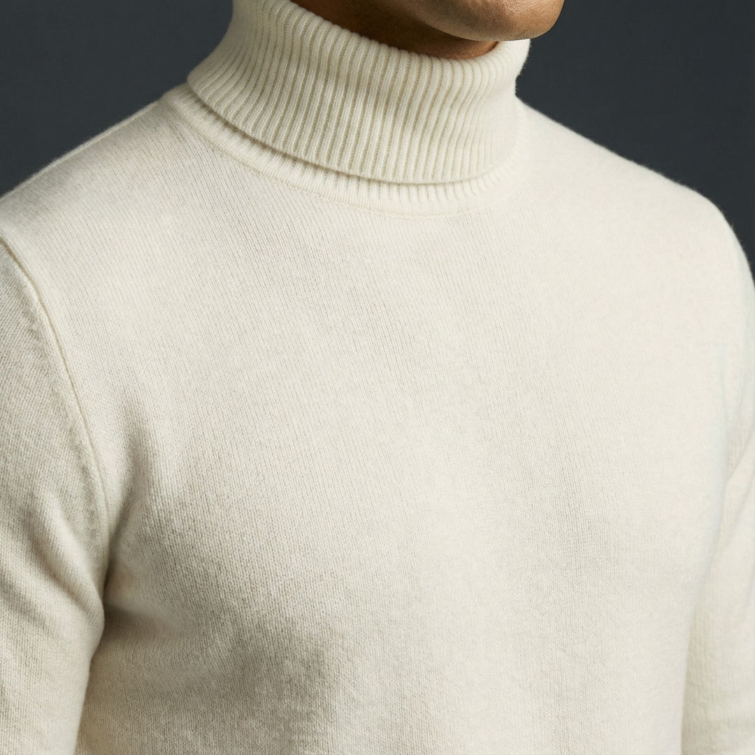 Man in a charcoal gray refined turtleneck, showcasing a slim fit and timeless elegant winter style.