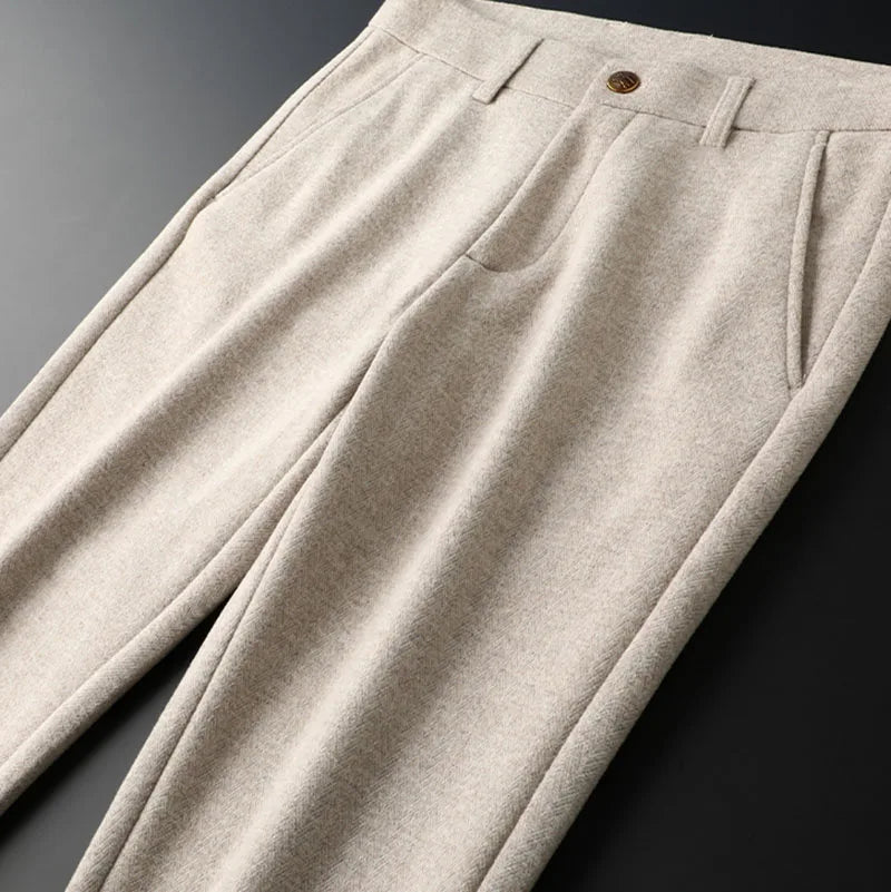Flat lay of Regent tailored men's dress pants, emphasizing sharp pleats and a refined, tailored design.