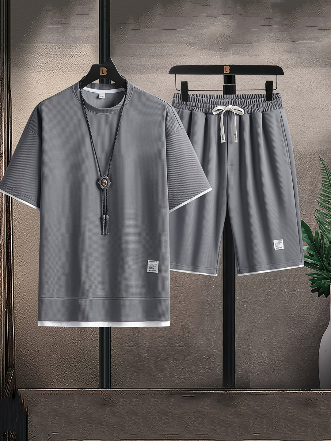 Men's relaxed fit black textured lounge set, a comfortable two-piece T-shirt and drawstring shorts for home wear.