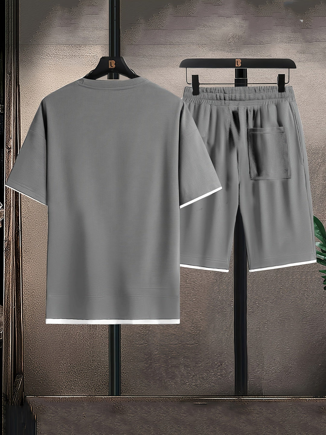 Grey men's casual textured lounge set with relaxed T-shirt and comfortable drawstring shorts, perfect for home.