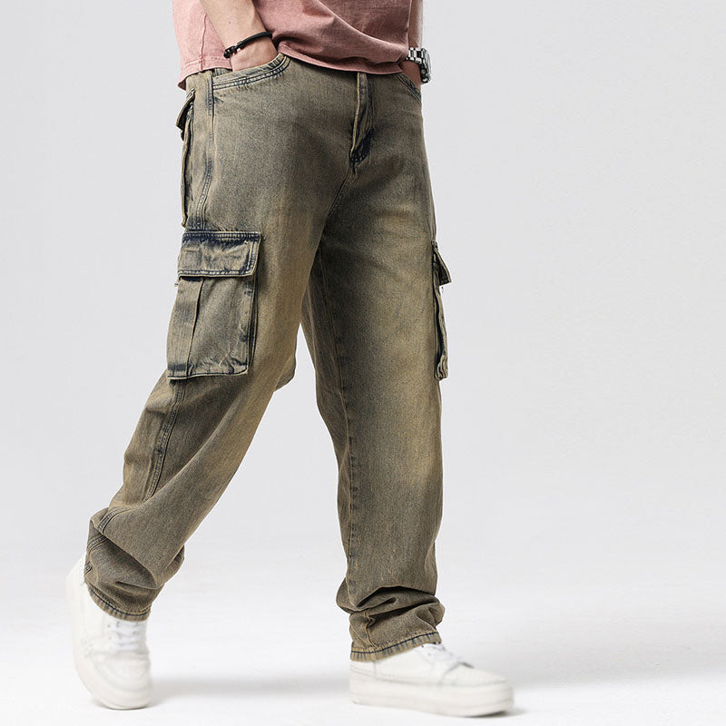 Detail of large utility pockets on men's relaxed fit blue cargo jeans, emphasizing practical design.