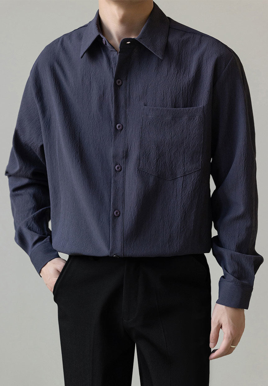 Man in a casual relaxed fit long-sleeve button-up shirt worn open, demonstrating versatile mens fashion style.