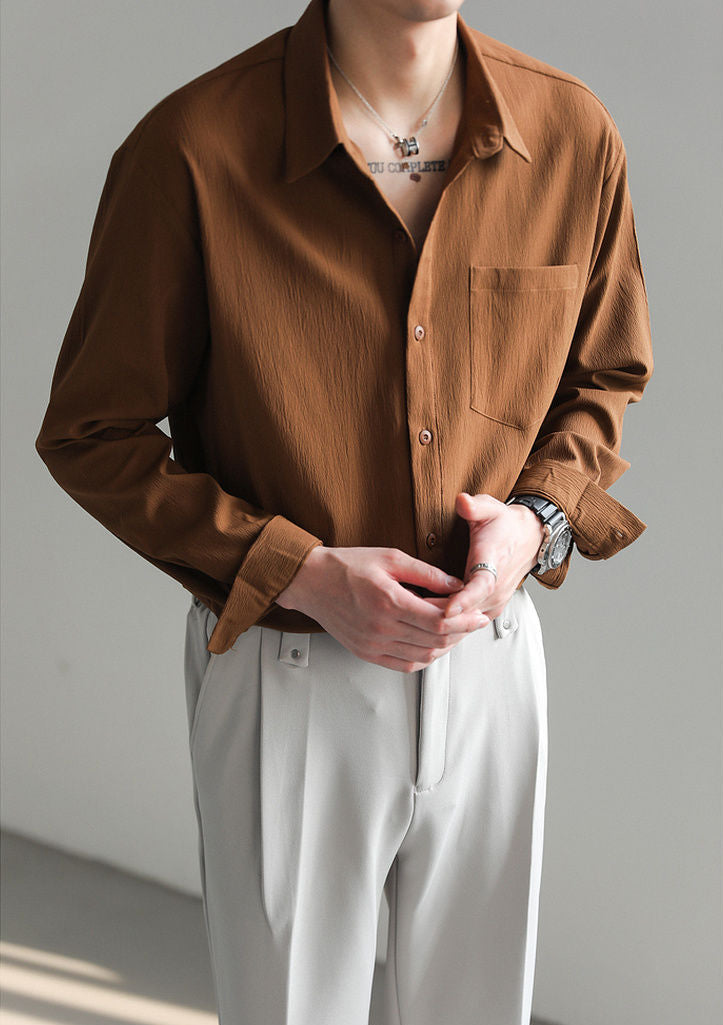 Lifestyle shot of man enjoying casual day in a comfortable long-sleeve relaxed fit button-up shirt, everyday wear.