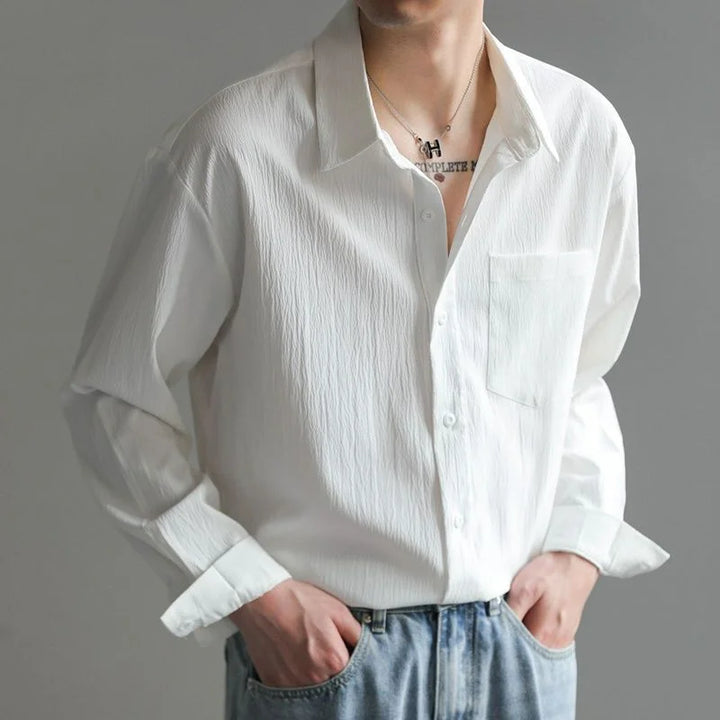 Front view of man in a stylish, casual men's relaxed fit long-sleeve button-up shirt for versatile everyday fashion.