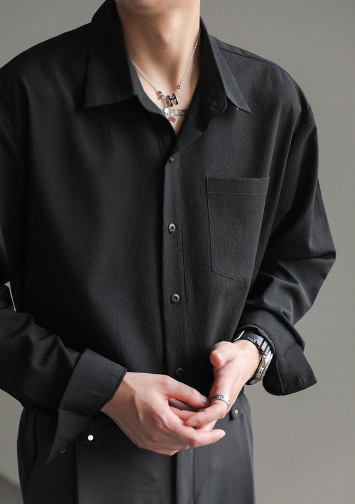 Men's casual relaxed fit long-sleeve button-up shirt on a hanger, showcasing its versatile design & comfort.