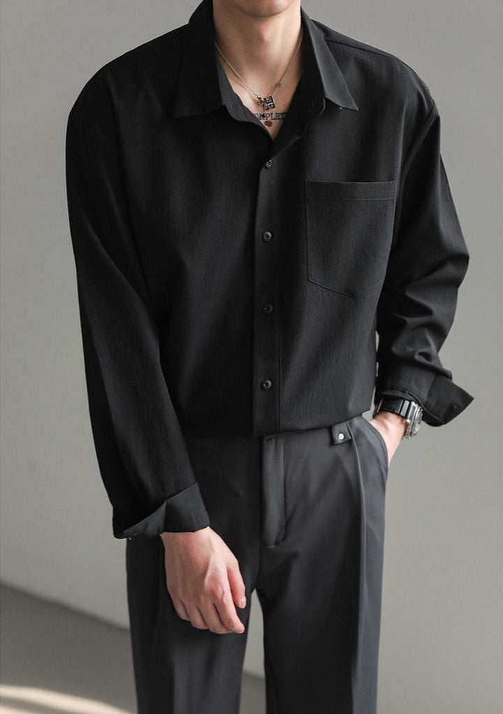 Detail shot of durable buttons on a men's relaxed fit long-sleeve button-up shirt, a comfort shirt feature.