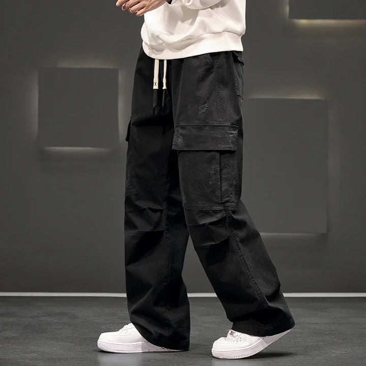 Stylish men's utility pants with multiple pockets, ideal for casual wear and outdoor activities.