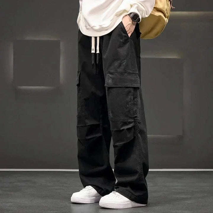 Men's relaxed fit cargo pants in black with a comfortable drawstring waist & multi-pockets for everyday utility.