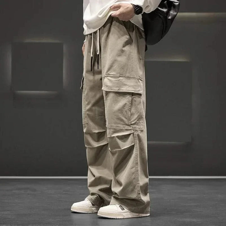 Men's relaxed fit utility cargo pants in black, featuring multiple spacious pockets & an adjustable drawstring waist.