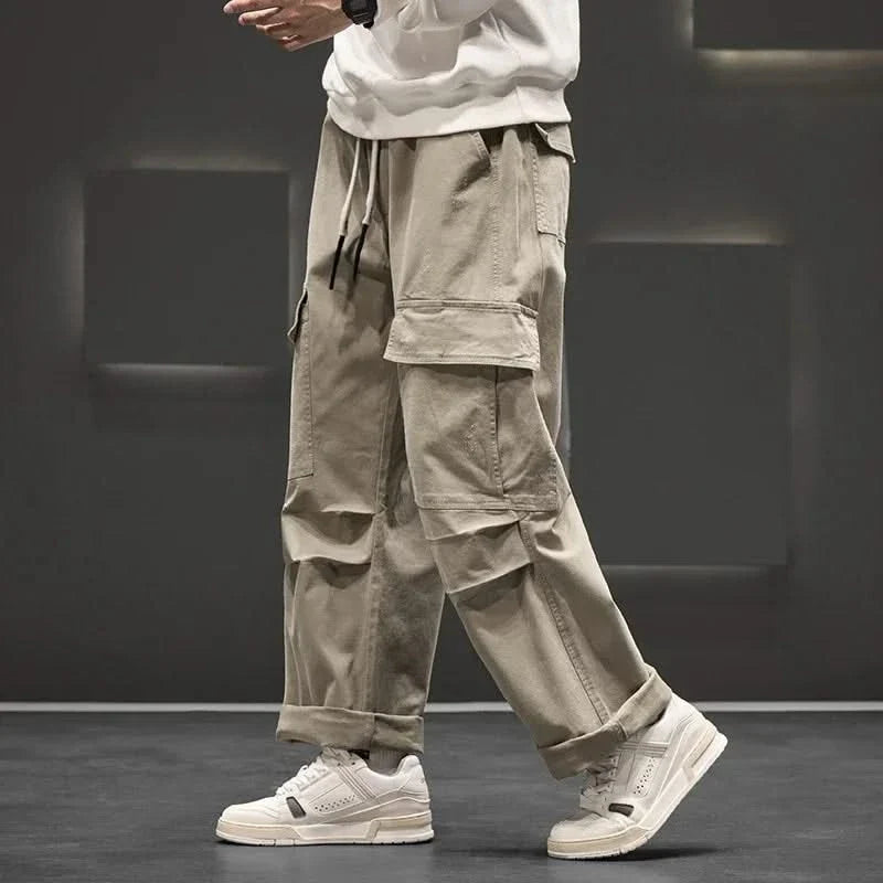 Stylish men's relaxed fit cargo pants, versatile for men's fashion, with a drawstring waist & multi-pocket design.