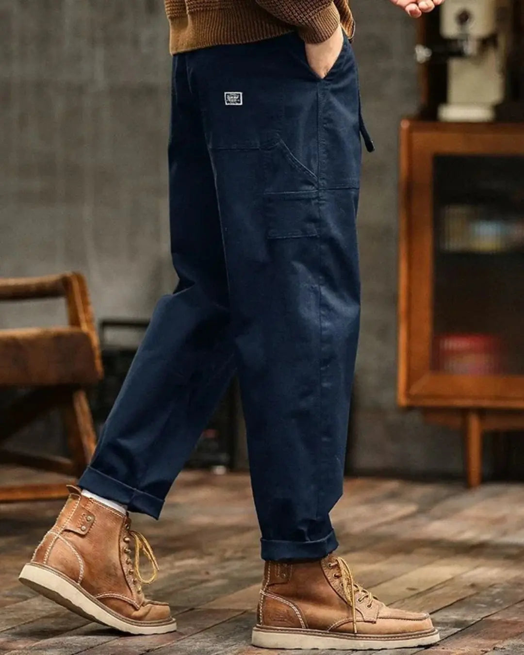 Man wearing relaxed fit cargo pants outdoors, showcasing multiple pockets and durable design.