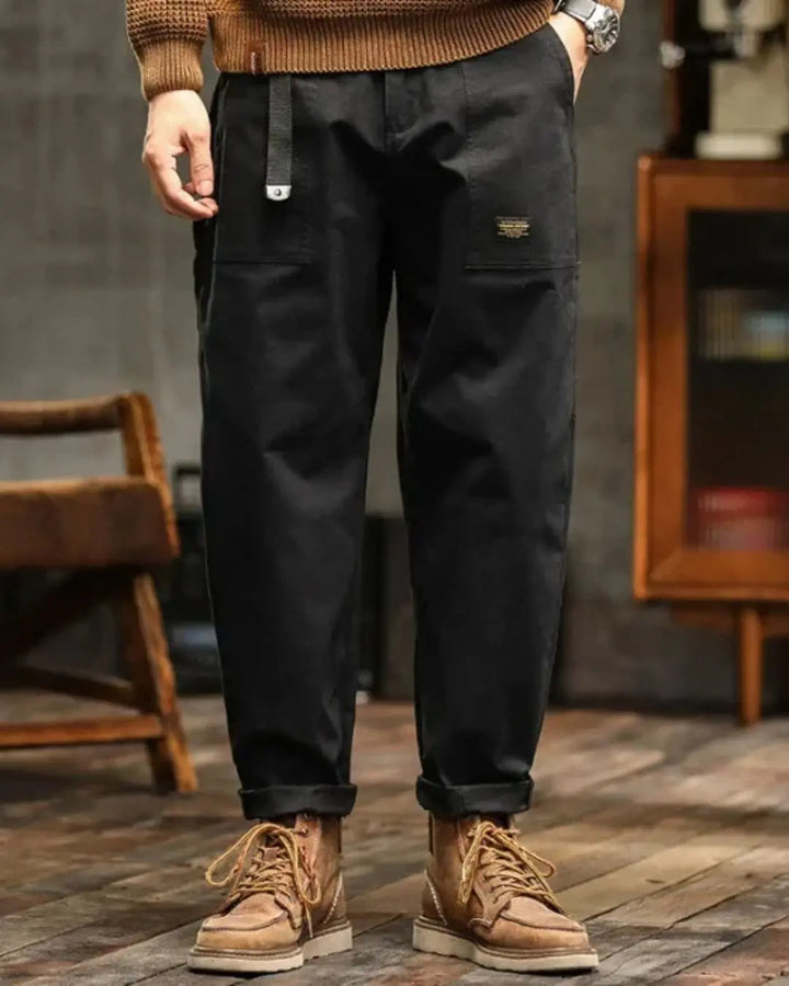 Close-up of men's relaxed fit cargo pants, highlighting practical side and back pockets for utility.