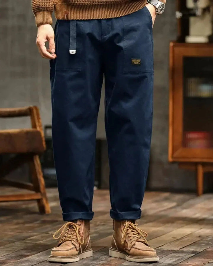 Rugged men's relaxed fit cargo pants, designed for durability and outdoor adventures with many pockets.