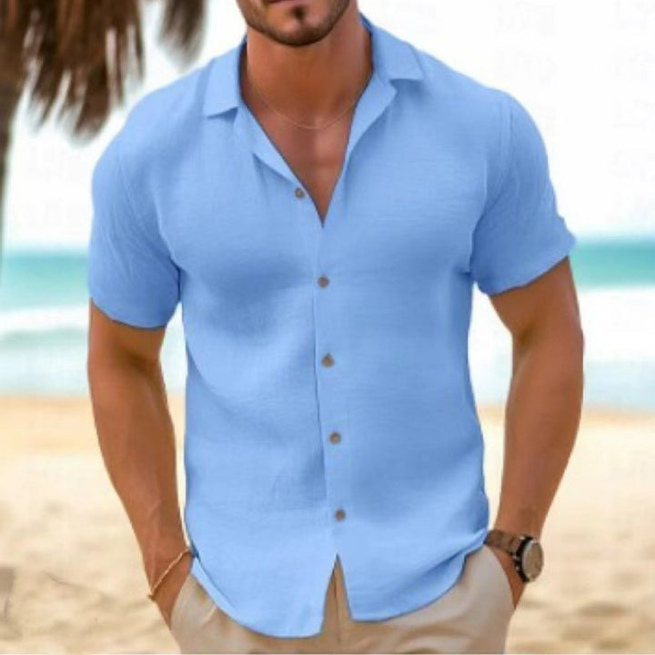 Man traveling in a relaxed fit collared shirt, a breathable short sleeve top for ultimate summer comfort.