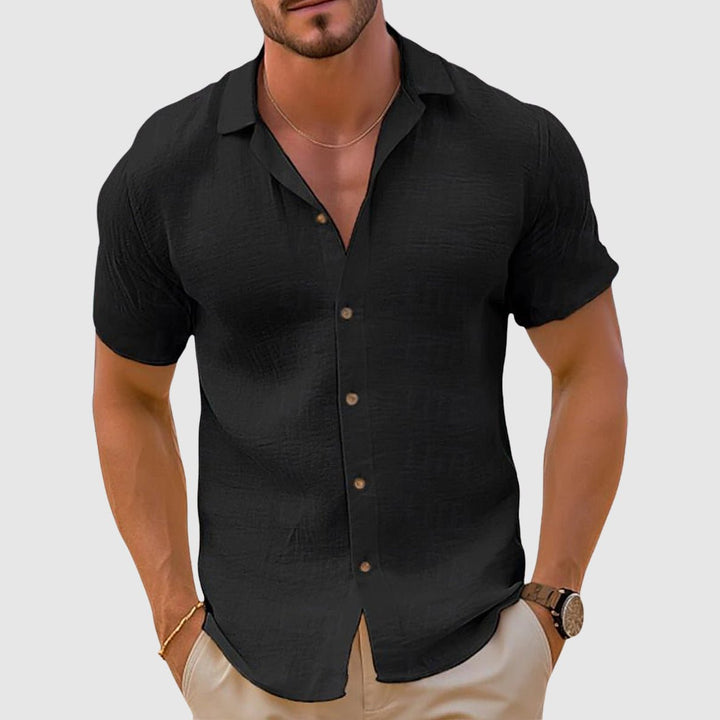 Man enjoying vacation in a comfortable relaxed fit collared shirt. Stylish short sleeve beachwear and travel essential.
