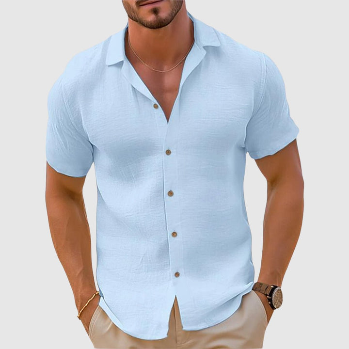 Folded men's relaxed fit collared shirt, a versatile short sleeve top for summer comfort and casual fashion.