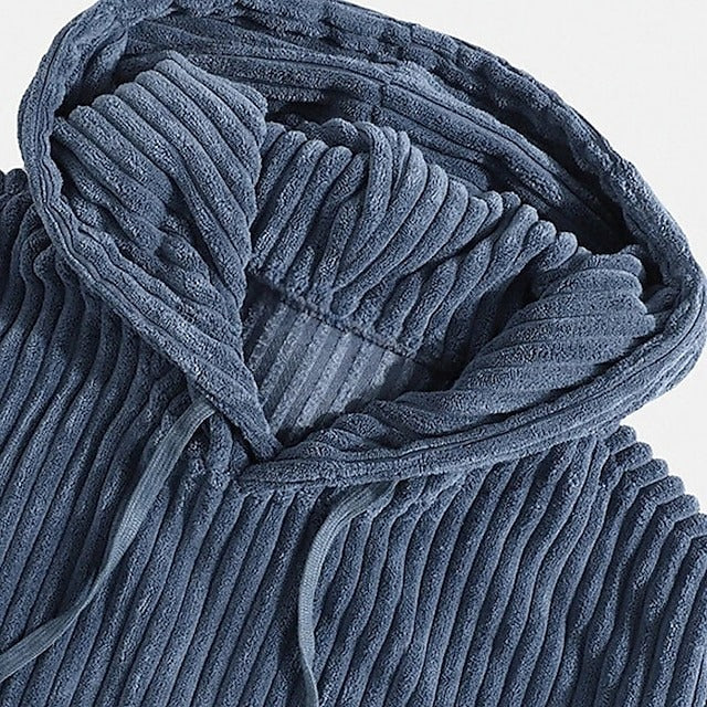 Man wearing a comfortable men's corduroy hoodie. Relaxed fit pullover, ideal for everyday fall fashion.