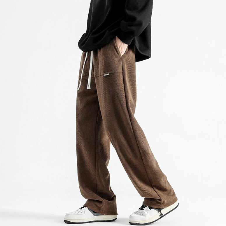 Men's relaxed fit corduroy pants with drawstring waist for casual all-season comfort.