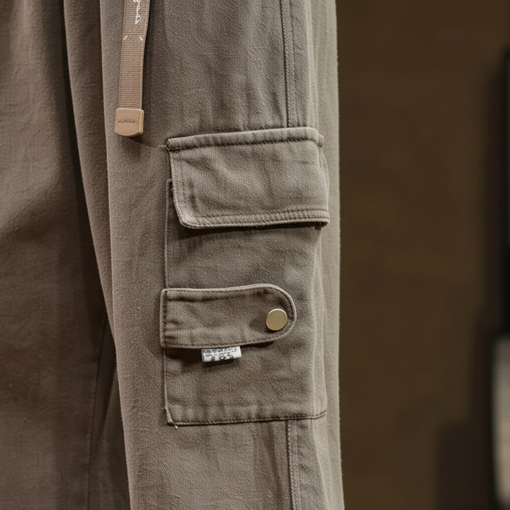 Close-up of men's casual relaxed fit cotton cargo pants fabric and durable stitching, men's apparel.