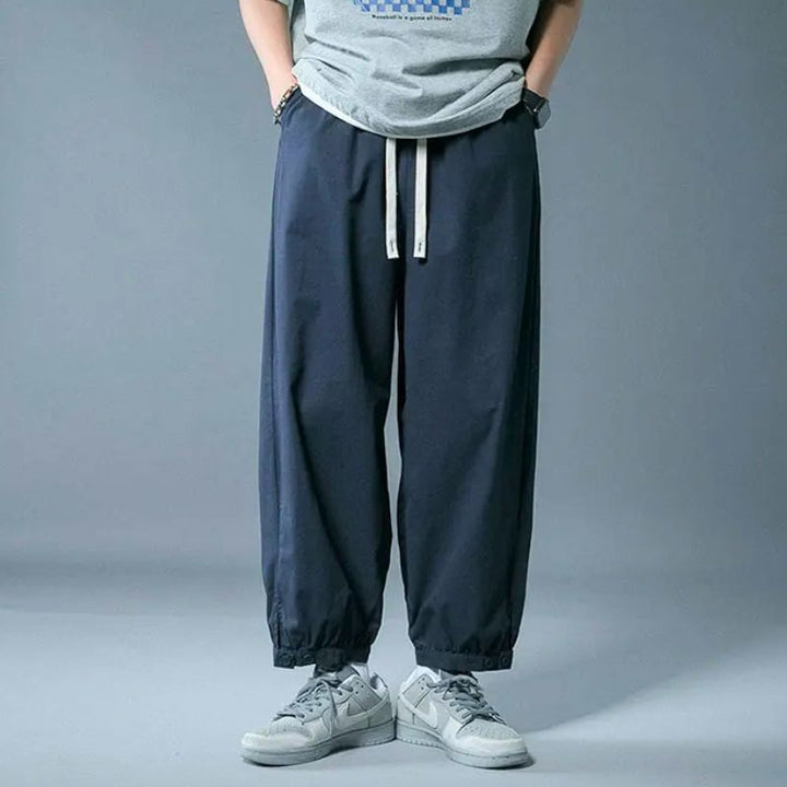 Soft men's comfort pants with a relaxed fit, adjustable drawstring, and elastic cuffs for versatile casual wear.