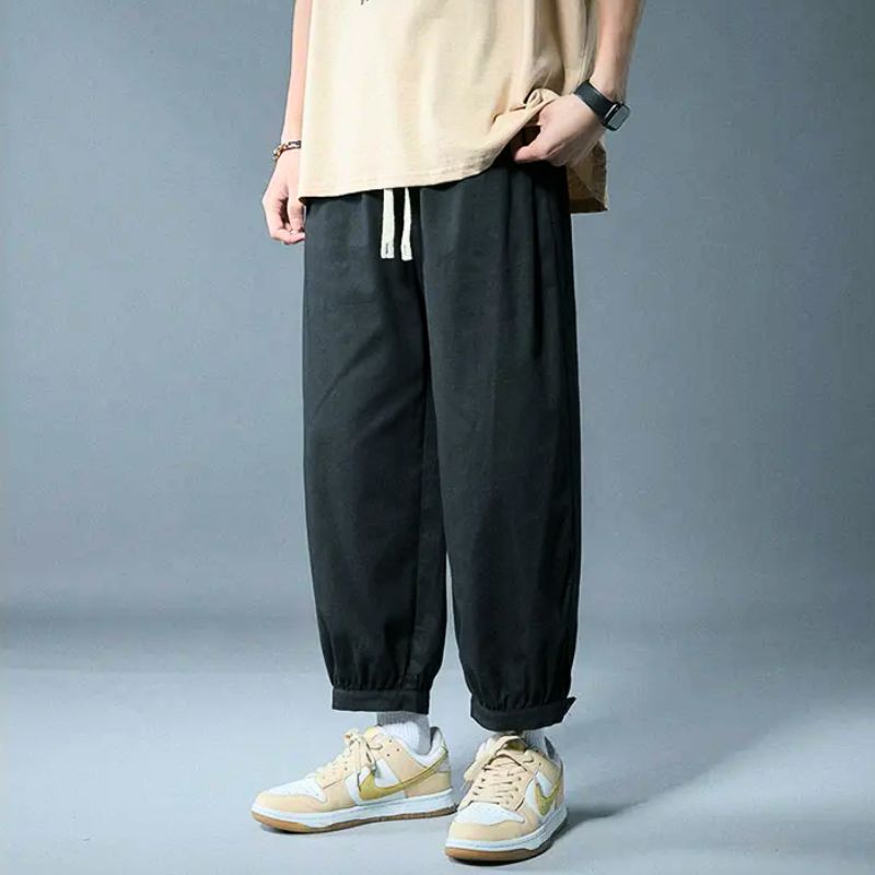 Men's casual drawstring pants, relaxed fit, elastic cuffs for comfort, perfect for versatile everyday loungewear.