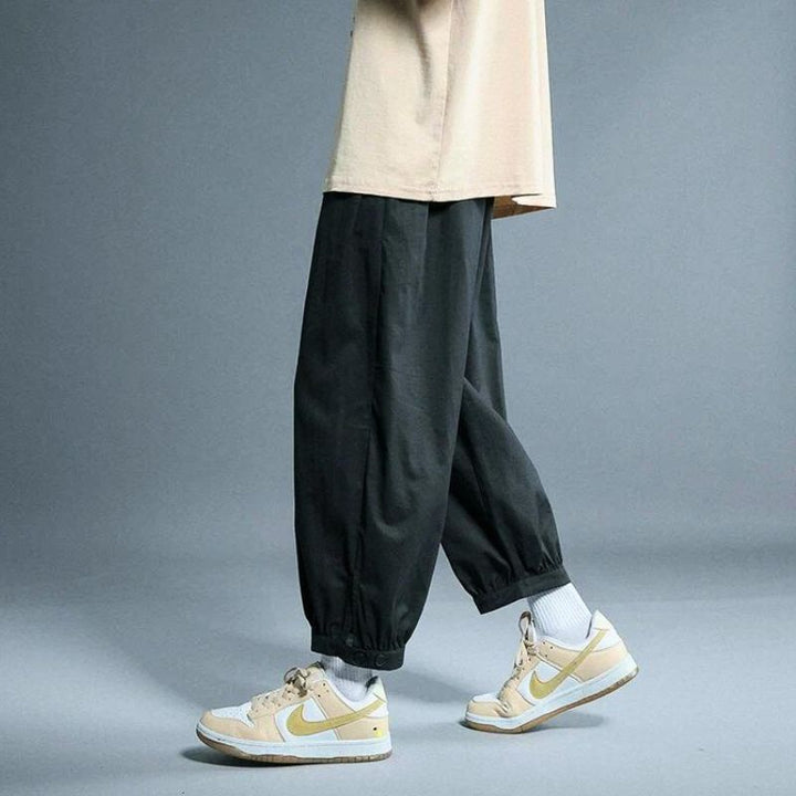 Relaxed fit men's drawstring pants with elastic cuffs, designed for ultimate comfort and casual everyday style.