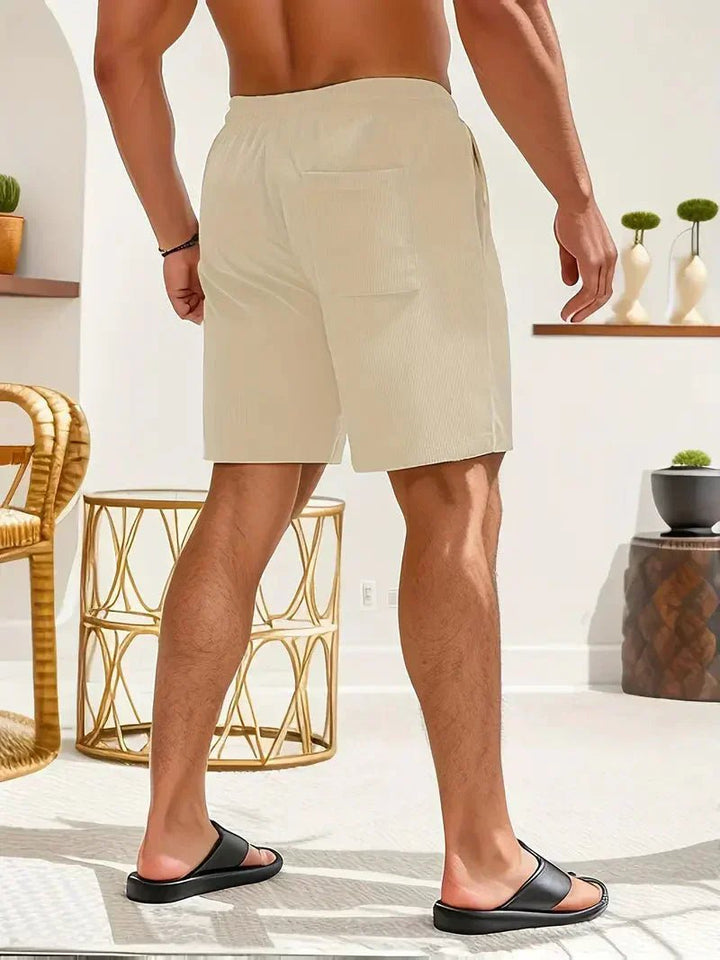 Stylish men's relaxed fit drawstring shorts, perfect for a modern casual summer aesthetic.